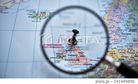 Magnifying glass highlighting BELFAST on paper map Magnifying glass highlighting BELFAST on paper map 141449898