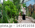 Asian tourist woman visiting cactus garden in Royal Park Rajapruek in Chiang Mai province of Thailand.  141451038
