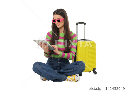 Traveler with luggage uses a tablet, isolated, PNG Traveler with luggage uses a tablet, isolated, PNG 141452049