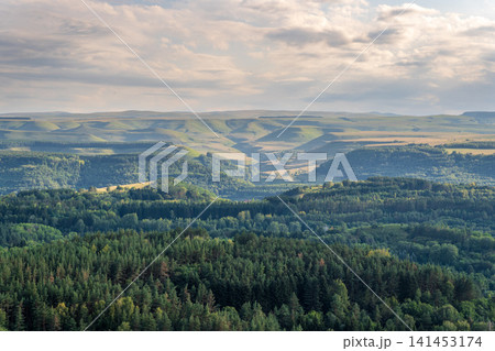 Layers of green mountains and hills in the haze during sunset. Panoramic View of Green hills and Meadow. 141453174