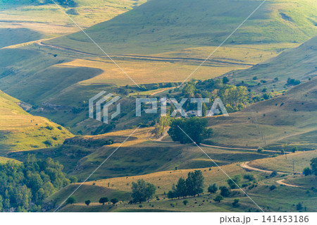 Layers of green mountains and hills in the haze during sunset. Panoramic View of Green hills and Meadow. Layers of green mountains and hills in the haze during sunset. Panoramic View of Green hills and Meadow. 141453186