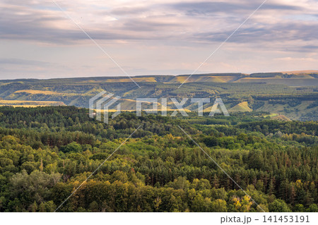 Layers of green mountains and hills in the haze during sunset. Panoramic View of Green hills and Meadow. Layers of green mountains and hills in the haze during sunset. Panoramic View of Green hills and Meadow. 141453191