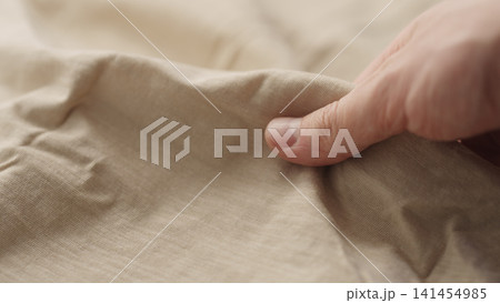 man hand checking natural cotton jersey cloth man hand checking natural cotton jersey cloth 141454985
