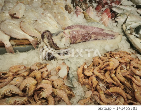 Dried gammarus crustaceans piled on ice alongside raw seafood at a market display, showcasing their natural brown texture and segmented bodies. Dried gammarus crustaceans piled on ice alongside raw seafood at a market display, showcasing their natural brown texture and segmented bodies. 141455583