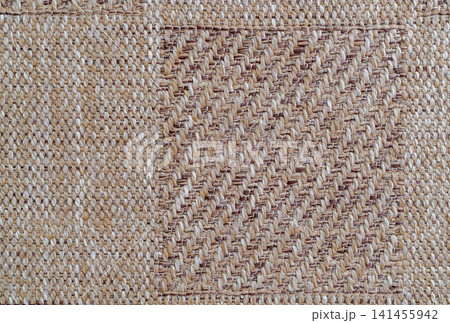 High angle view of a rectangular canvas sample patch on a woven beige textile background High angle view of a rectangular canvas sample patch on a woven beige textile background 141455942