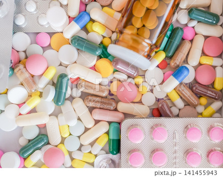 Colorful healthcare background made of multi-colored medical tablets, pills, blister packs, and capsules Colorful healthcare background made of multi-colored medical tablets, pills, blister packs, and capsules 141455943