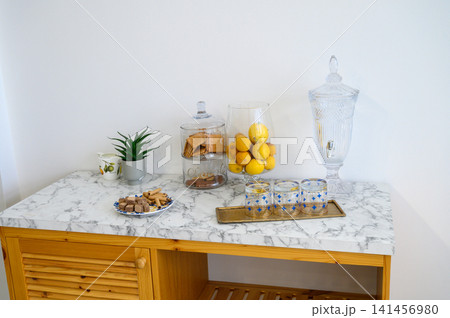 Charming display of treats and decor on a marble topped dining table 141456980