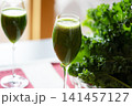 Fresh organic kale smoothie with kale leaves in background. 141457127
