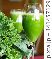 Fresh organic kale smoothie with kale leaves in background. 141457129
