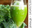 Fresh organic kale smoothie with kale leaves in background. 141457130