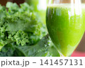 Fresh organic kale smoothie with kale leaves in background. 141457131