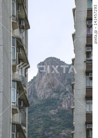 Hong Kong. July 19 2026 Lion Rock peak framed between highrise apartment buildings. 141457293