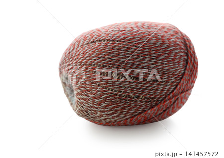 Vibrant yarn ball resting in soft light with intricate patterns and colors Vibrant yarn ball resting in soft light with intricate patterns and colors 141457572