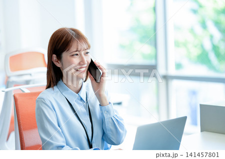 電話する女性スタッフ 電話する女性スタッフ 141457801