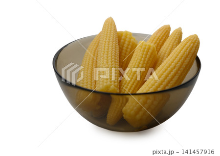 Fresh baby corn cobs in a glass bowl on a white background Fresh baby corn cobs in a glass bowl on a white background 141457916