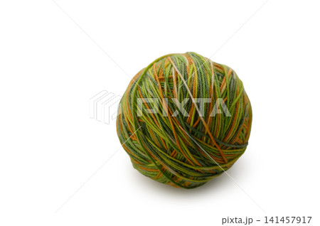 Colorful yarn ball softly resting on a white background, inviting creativity during a cozy afternoon craft session Colorful yarn ball softly resting on a white background, inviting creativity during a cozy afternoon craft session 141457917