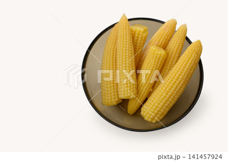 Freshly harvested yellow corn cobs create a vibrant display in a simple bowl, showcasing nature bounty ready for cooking or snacking 141457924