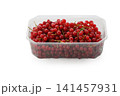Vibrant clusters of fresh red currants showcasing nature's beauty in a clear plastic container on a bright white background 141457931