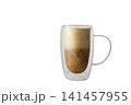 A double-walled glass mug of coffee with frothed milk 141457955