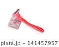 Bright pink razor resting on its sleek holder, ready for smooth shaving moments in a bright bathroom setting 141457957