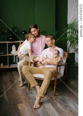 Loving Young Family With Two Children At Home Loving Young Family With Two Children At Home 141458355