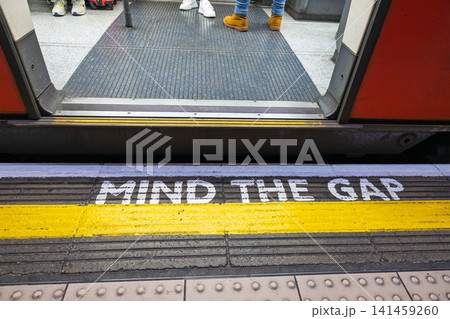 Mind the gap safety warning text on subway platform edge 141459260