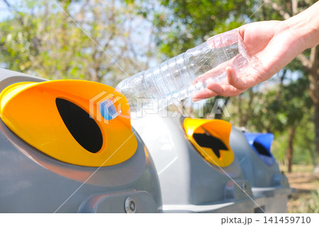 Please dispose of plastic bottle into the tank. A man throw rubbish in the trash can by separate garbage to dispose like hazardous waste , Please dispose of plastic bottle into the tank. A man throw rubbish in the trash can by separate garbage to dispose like hazardous waste , 141459710