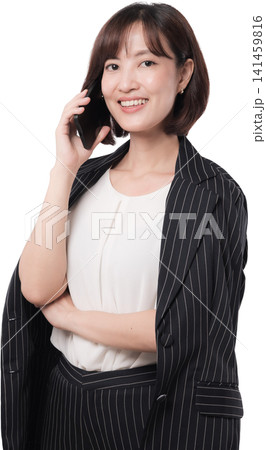 Cheerful asian woman wearing business blazer holding mobile phone with happy expression presenting studio communication isolated plain transparency background studio shot. PNG file format Cheerful asian woman wearing business blazer holding mobile phone with happy expression presenting studio communication isolated plain transparency background studio shot. PNG file format 141459816