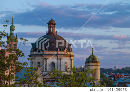 A panoramic view of ancient architecture featuring prominent domes and spires against a dramatic sky, showcasing a historical urban landscape A panoramic view of ancient architecture featuring prominent domes and spires against a dramatic sky, showcasing a historical urban landscape 141459978