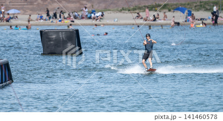 Cable Wakeboarder Riding on Lake in Summer Cable Wakeboarder Riding on Lake in Summer 141460578
