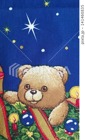 Festive fabric print of a teddy bear surrounded by holly, ribbons, ornaments, and candles against a starry blue night sky. Festive fabric print of a teddy bear surrounded by holly, ribbons, ornaments, and candles against a starry blue night sky. 141460835