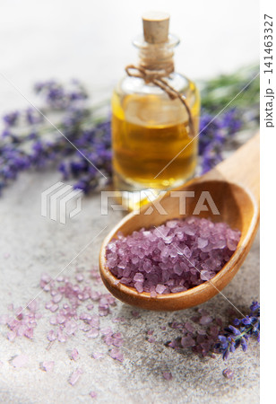 Relaxing spa setting with lavender essential oil and bath salt Relaxing spa setting with lavender essential oil and bath salt 141463327
