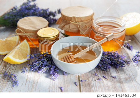 Honey jars with lavender on rustic wooden background 141463334