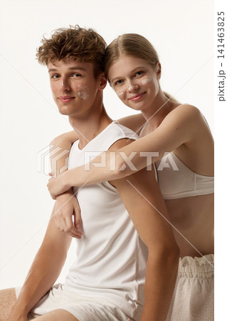 Confident fair-skinned young couple embracing in vertical clean beauty portrait Confident fair-skinned young couple embracing in vertical clean beauty portrait 141463825