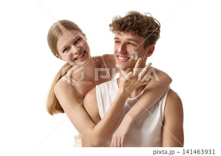 Laughing young Caucasian couple sharing playful touch in beauty portrait Laughing young Caucasian couple sharing playful touch in beauty portrait 141463931