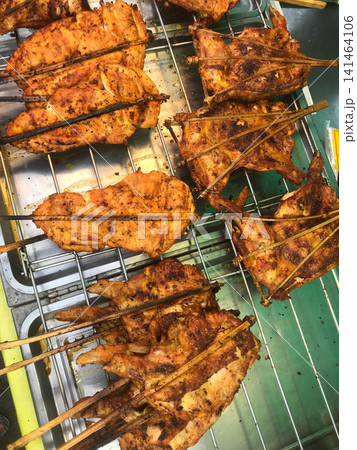 Thai Grilled chicken cooking on charcoal Thai Grilled chicken cooking on charcoal 141464106