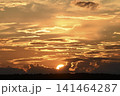 The evening horizon. The sun is in the clouds. A bright yellow-pink sunset. 141464287