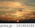 The evening horizon. The sun is in the clouds. A bright yellow-pink sunset. 141464288