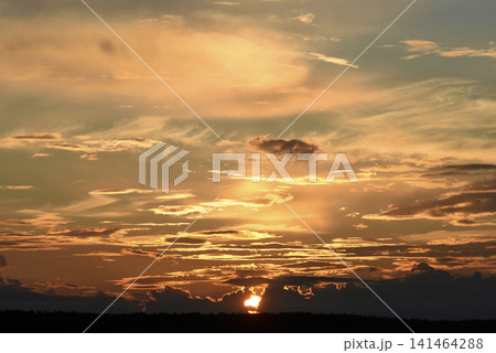 The evening horizon. The sun is in the clouds. A bright yellow-pink sunset. 141464288