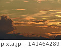 The evening horizon. The sun is in the clouds. A bright yellow-pink sunset. 141464289