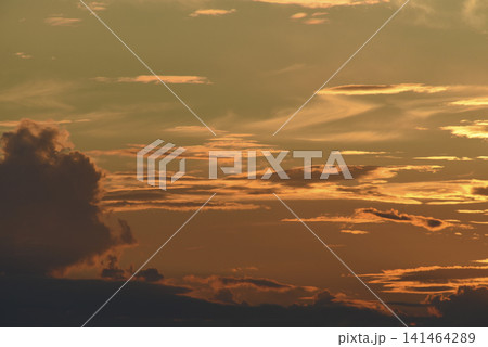 The evening horizon. The sun is in the clouds. A bright yellow-pink sunset. 141464289