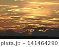 The evening horizon. The sun is in the clouds. A bright yellow-pink sunset. 141464290