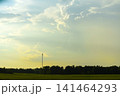 The evening horizon in the clouds and the communications tower. 141464293