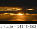 The evening horizon. The sun is in the clouds. A bright yellow-pink sunset. 141464302