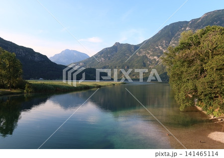Alpine Peak and Mountain Reflection on Calm Lake in Italy Alpine Peak and Mountain Reflection on Calm Lake in Italy 141465114