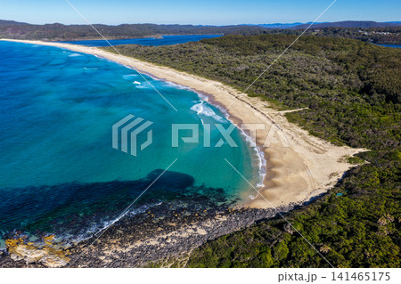 Aerial view of the pristine coastline at Celito Beach with the crystal clear waters of the Pacific Ocean, sandy shoreline and Smiths Lake visible in the background on the Mid North Coast of NSW. Aerial view of the pristine coastline at Celito Beach with the crystal clear waters of the Pacific Ocean, sandy shoreline and Smiths Lake visible in the background on the Mid North Coast of NSW. 141465175