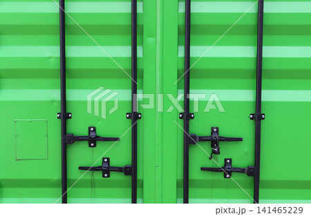 Locking Handles And Bolted Locking Beams On A Green Metal Cargo Container Door. Freight Container Door Texture. Metal Cargo Box Pattern Locking Handles And Bolted Locking Beams On A Green Metal Cargo Container Door. Freight Container Door Texture. Metal Cargo Box Pattern 141465229