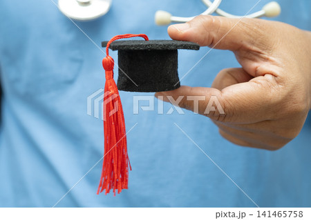 Asian doctor study learn with graduation gap hat in hospital ward, clever bright genius education medicine. Asian doctor study learn with graduation gap hat in hospital ward, clever bright genius education medicine. 141465758