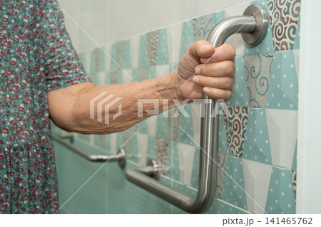 Asian elderly woman patient use toilet bathroom handle security in nursing hospital, healthy strong medical. Asian elderly woman patient use toilet bathroom handle security in nursing hospital, healthy strong medical. 141465762