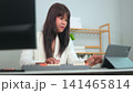young woman working on laptop 141465814